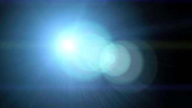 Bright light with lens flare moving. Background with spotlight beam. 