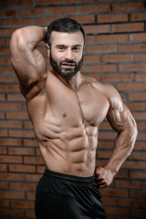Fototapeta na wymiar Fitness instructor handsome man in the gym gain muscle