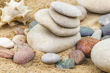 Fototapeta na wymiar Pebbles stacked on sand