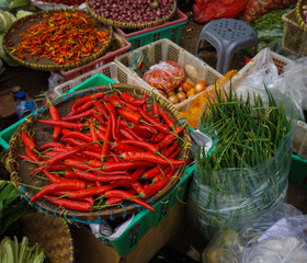 Green grocer sells various kind of vegetables at traditional market in Jakarta Indonesia