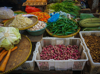 Green grocer sells various kind of vegetables,herbs and spices at traditional market in Jakarta Indonesia