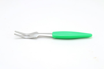 Small fork for fruit on white background