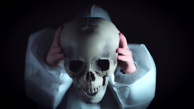 4k Creepy Shot of Child in Respirator Mask Holding a Skull