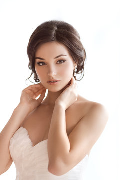 Beautiful brunette asian woman as bride on white background