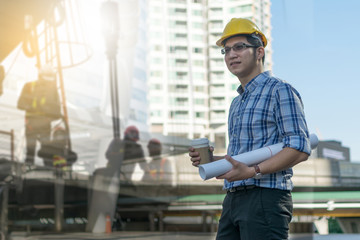 Foreman construction worker holding blueprint