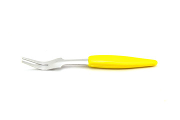 Small fork for fruit on white background