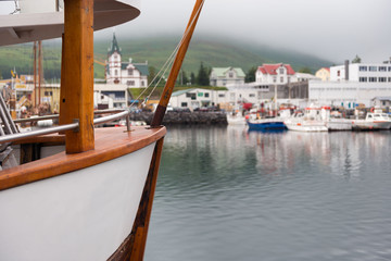 Husavik, Iceland - Fishing boats moored at harbour in subdued li