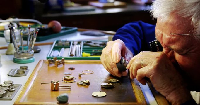 Horologist repairing a watch