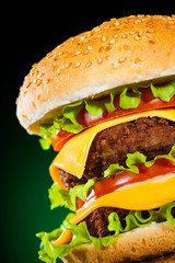 Tasty and appetizing hamburger on a darkly green
