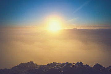 Obraz premium Bright Sun Above Clouds Seeing from the Top of Mountain