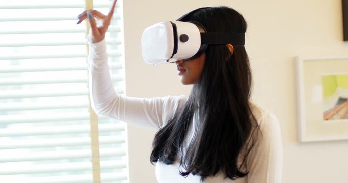 Woman using virtual reality headset in living room