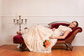 victorian woman on couch with orange roses
