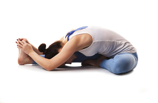 Flexible young woman practicing yoga and gymnastics.