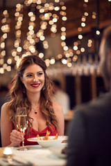 Girlfriend with boyfriend at romantic dinner.