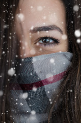 Winter portrait of young beautiful woman with snow