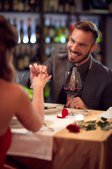 Male engaged attractive woman in restaurant