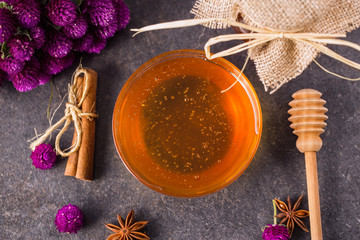 honey in glass bowl with honey dipper.