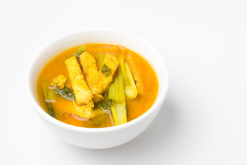 Sour soup made of tamarind paste with chinese cabbage and pork grilled in bowl on white background