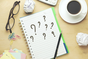Question Mark written on a white notebook