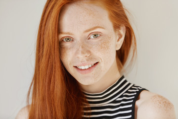 Beauty and skin care. Highly-detailed portrait of attractive redhead teenage girl with charming...