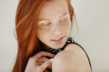 Highly-detailed shot of tender and cute teenage female with shy faint smile, loose ginger hair and...