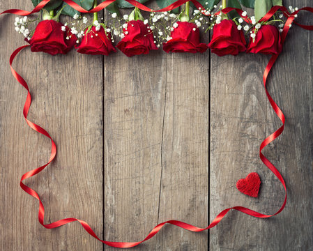 Red roses with ribbon frame.