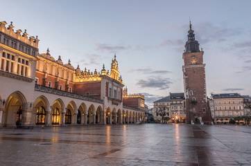 Fototapeta premium Cloth Hall and Town Hall tower on the Main Market Square in Krakow, Poland, illuminated in the morning
