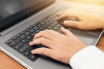 businessman hand using keyboard on computer laptop