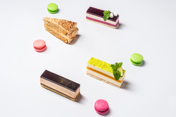 Several pieces of cake and makarons