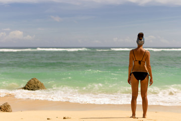 Sexy back of a beautiful woman in bikini, on sea background. 