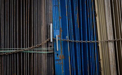 Blue and grey metal rolling door locked by chain photo taken in Jakarta indonesia