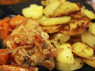 Fried potato and fried fish and the black plate