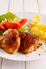 Grilled chicken thighs with boiled potatoes and vegetable salad 