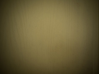 abstract brown background or brown wood texture with warm center spotlight and black vignette...