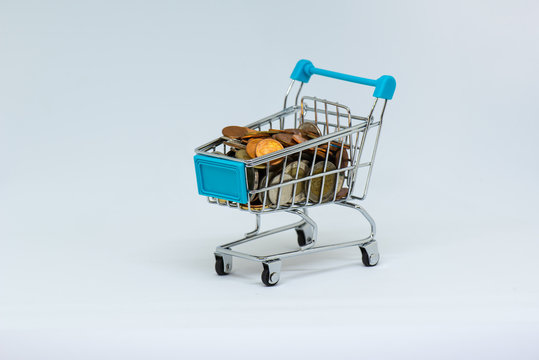 Closeup of shopping cart full load coin. Financial concept