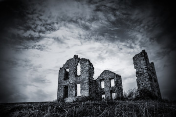Black and White image of an abandoned stone house