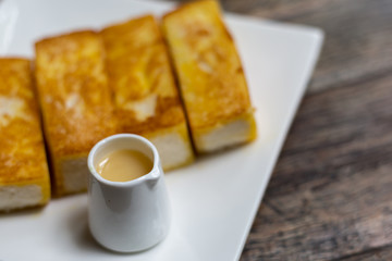 Toast bread served with sweet syrup.,toast butter served with sw