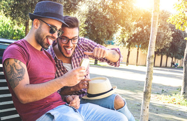 Two handsome friends taking a selfie with a smart phone