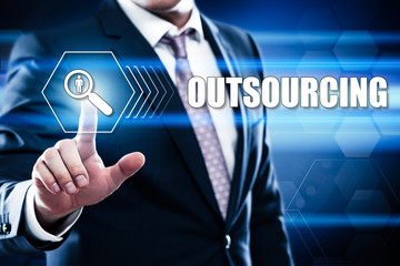 Business, technology, internet concept on hexagons and transparent honeycomb background. Businessman  pressing button on touch screen interface and select  outsourcing