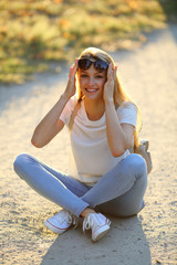 Smilling young woman sitting on the earth