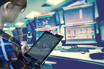 Double exposure of  women Engineer in hipster shirt  working with tablet in control room of oil and...