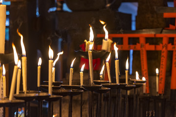 Religious candles and flames in a temple in Japan