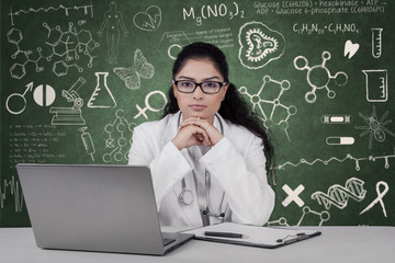 Confident doctor and doodles on the chalkboard