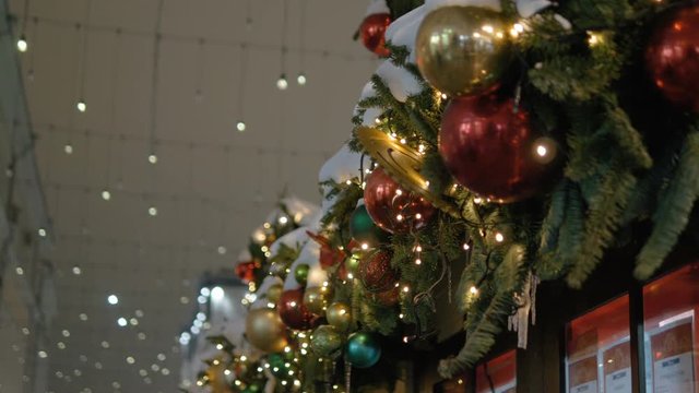 Christmas decoration balls hanging on tree on the background lights garland