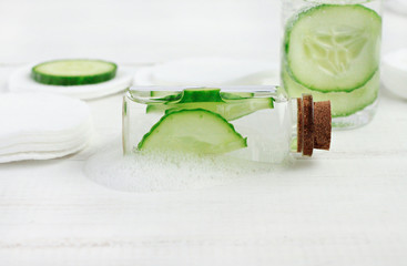 Facial lotion. Hydrating skincare gel in bottle with foam, horizontal, green cucumber, white...