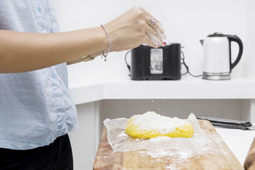 Housewife pouring flour for pie dough