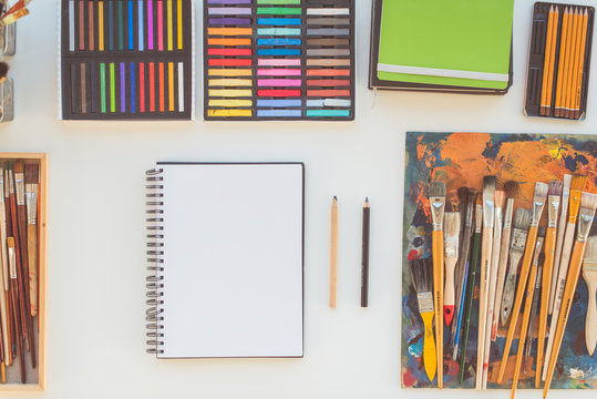 Painter workplace in order side view. Designer desk with drawing equipment. Home studio for artist