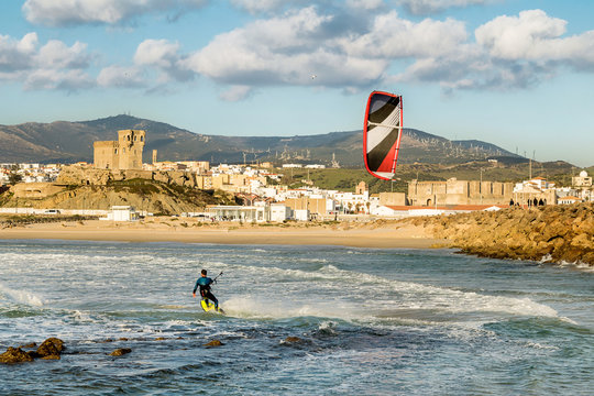 Man practicing kitesurfing on the beach of Tarifa, Spain. Tarifa is considered the capital of the wind, and favorite place for lovers of this sport.