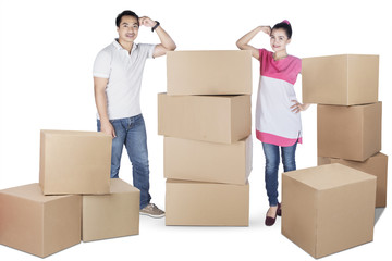 Wife and husband standing besides box