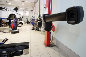 Wheel alignment equipment in a car repair station - obrazy, fototapety, plakaty